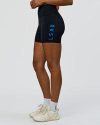 Woman wearing Rep Ultra High-Rise 4" Short Pockets - Black-Palace Blue | Model:Rosie | Size:S | Thumbnail Index: 0