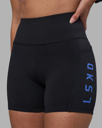 Woman wearing Rep Ultra High-Rise 4" Short Pockets - Black-Power Cobalt | Model:Rhiley | Size:S | Thumbnail Index: 2