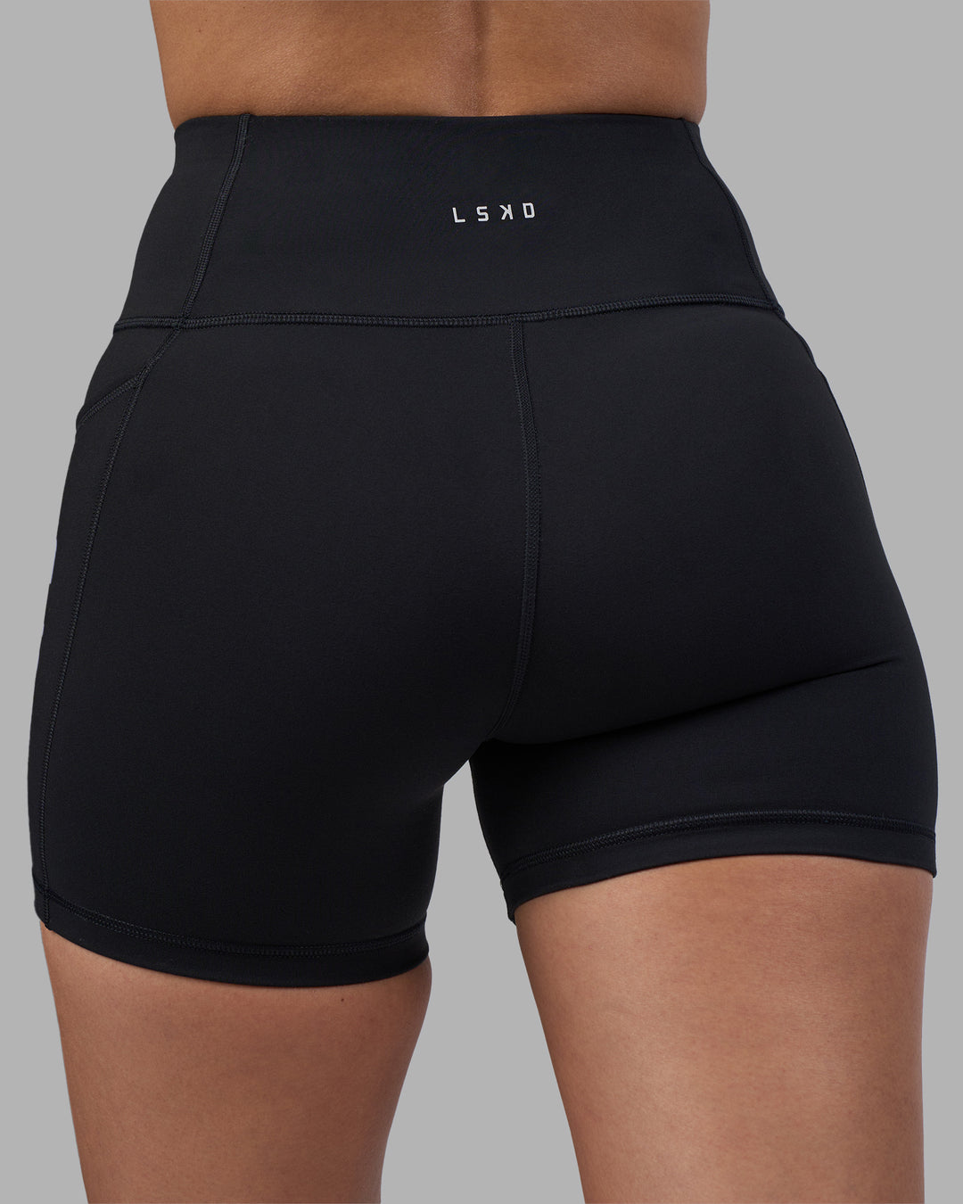 Woman wearing Rep Ultra High-Rise 4" Short Pockets - Black-Power Cobalt | Model:Rhiley | Size:S - view 8
