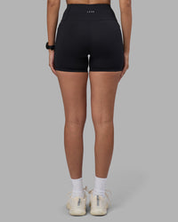 Woman wearing Rep Ultra High-Rise 4" Short Pockets - Black-Power Cobalt | Model:Rhiley | Size:S | Thumbnail Index: 3