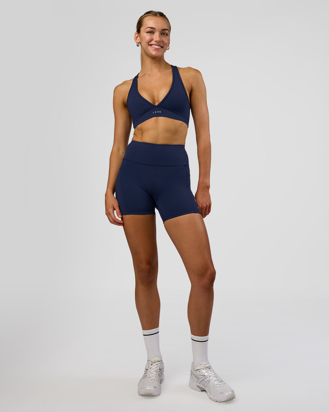 Woman wearing Rep Ultra High-Rise 4" Short Pockets - Future Navy-White | Model:Evie | Size:S - view 2
