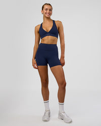 Woman wearing Rep Ultra High-Rise 4" Short Pockets - Future Navy-White | Model:Evie | Size:S | Thumbnail Index: 1