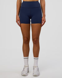 Woman wearing Rep Ultra High-Rise 4" Short Pockets - Future Navy-White | Model:Evie | Size:S | Thumbnail Index: 6