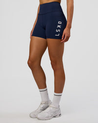 Woman wearing Rep Ultra High-Rise 4" Short Pockets - Future Navy-White | Model:Evie | Size:S | Thumbnail Index: 2