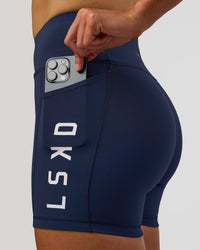 Woman wearing Rep Ultra High-Rise 4" Short Pockets - Future Navy-White | Model:Evie | Size:S | Thumbnail Index: 5
