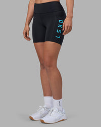 Woman wearing Rep Ultra High-Rise 6" Short Pockets - Black-Blue Atoll | Model:Sophie | Size:S | Thumbnail Index: 0