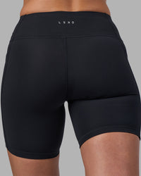 Woman wearing Rep Ultra High-Rise 6" Short Pockets - Black-Blue Atoll | Model:Sophie | Size:S | Thumbnail Index: 8