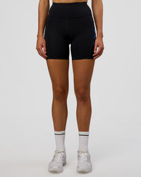 Woman wearing Rep Ultra High-Rise 6" Short Pockets - Black-Electric Indigo | Model:Evie | Size:S | Thumbnail Index: 6