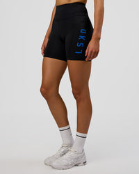 Woman wearing Rep Ultra High-Rise 6" Short Pockets - Black-Electric Indigo | Model:Evie | Size:S | Thumbnail Index: 0
