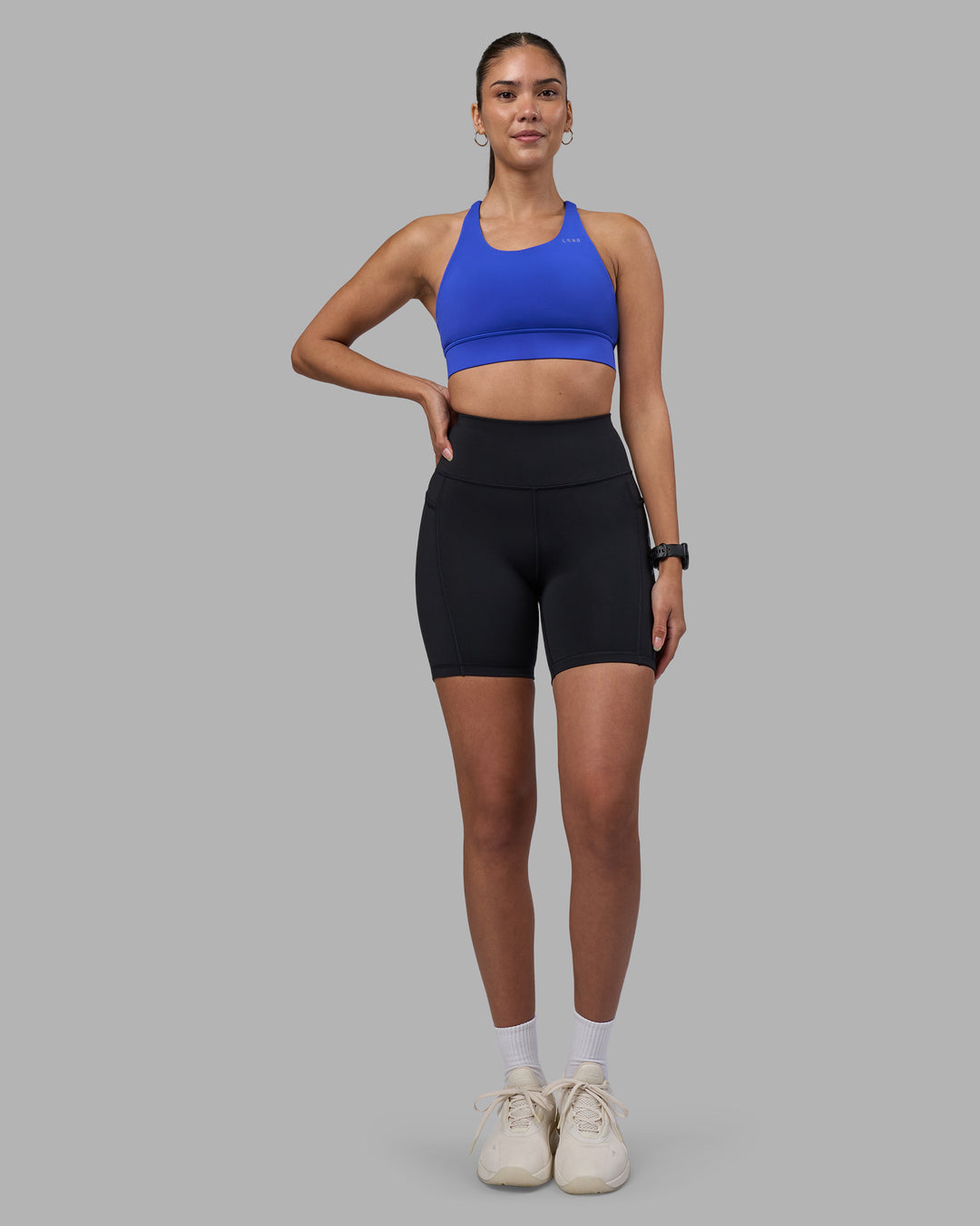 Woman wearing Rep Ultra High-Rise 6" Short Pockets - Black-Power Cobalt | Model:Rhiley | Size:S - view 5
