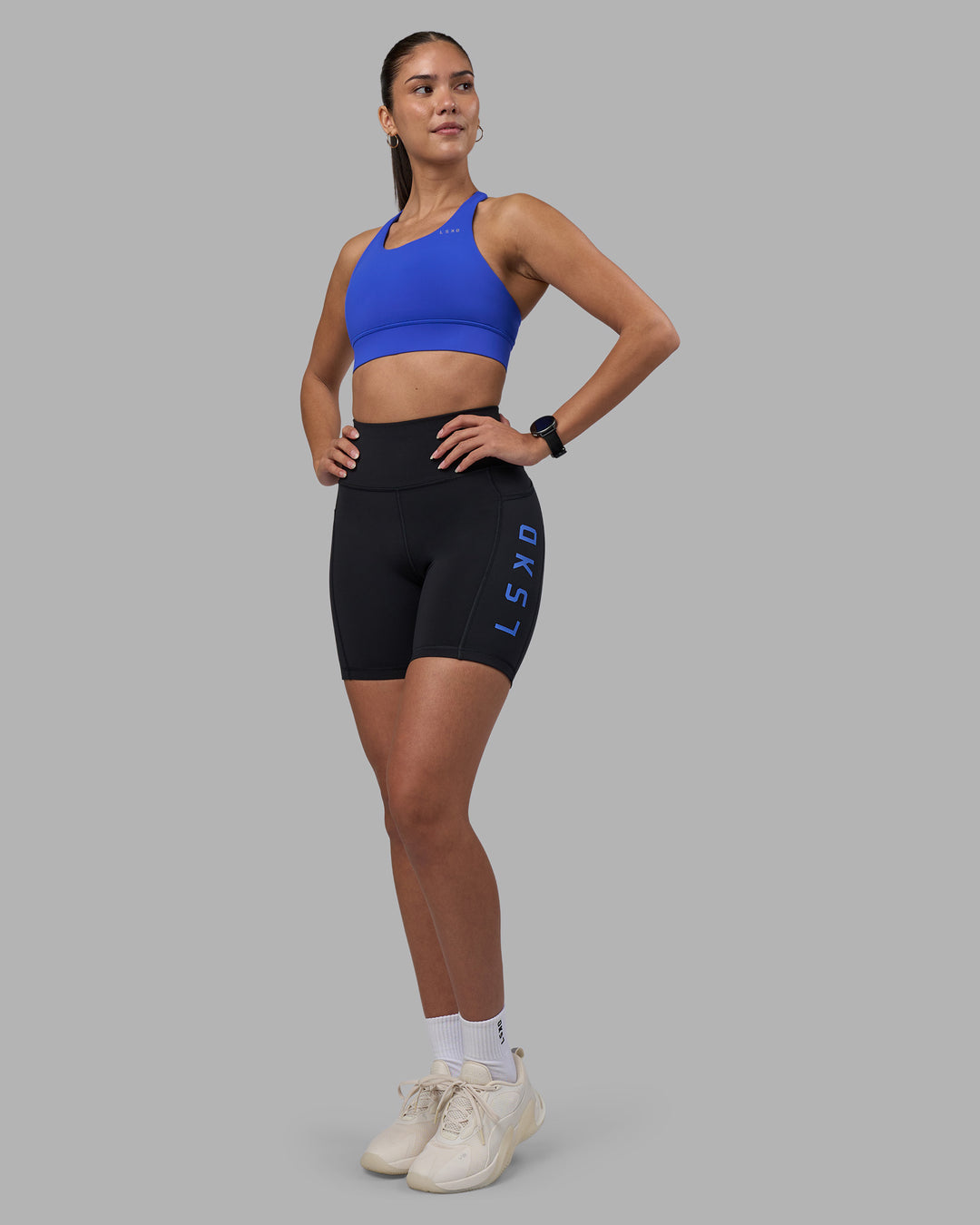 Woman wearing Rep Ultra High-Rise 6" Short Pockets - Black-Power Cobalt | Model:Rhiley | Size:S - view 2