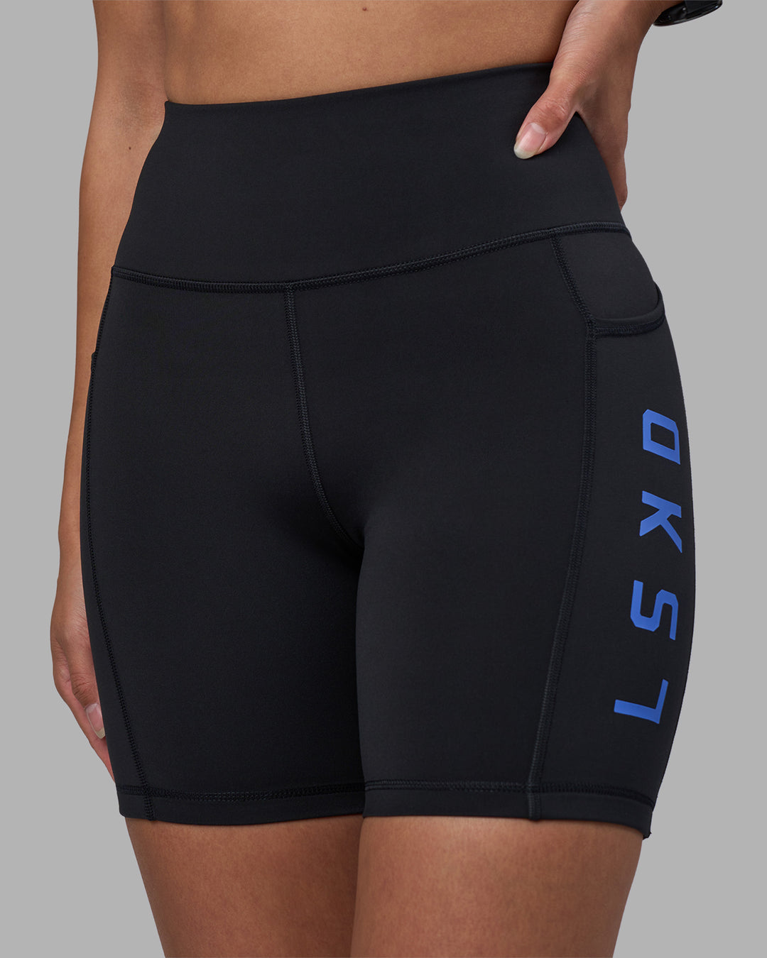 Woman wearing Rep Ultra High-Rise 6" Short Pockets - Black-Power Cobalt | Model:Rhiley | Size:S - view 6