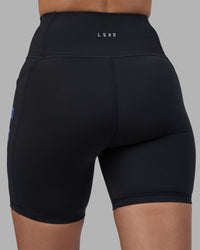 Woman wearing Rep Ultra High-Rise 6" Short Pockets - Black-Power Cobalt | Model:Rhiley | Size:S | Thumbnail Index: 7