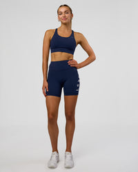 Woman wearing Rep Ultra High-Rise 6" Short Pockets - Future Navy-White | Model:Evie | Size:S | Thumbnail Index: 5