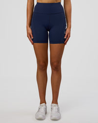 Woman wearing Rep Ultra High-Rise 6" Short Pockets - Future Navy-White | Model:Evie | Size:S | Thumbnail Index: 6