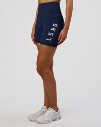 Woman wearing Rep Ultra High-Rise 6" Short Pockets - Future Navy-White | Model:Evie | Size:S | Thumbnail Index: 0