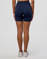 Woman wearing Rep Ultra High-Rise 6" Short Pockets - Future Navy-White | Model:Evie | Size:S | Thumbnail Index: 7
