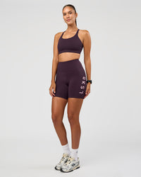 Woman wearing Rep Ultra High-Rise 6" Short Pockets - Midnight Plum-Marshmallow | Model:Rhiley | Size:S | Thumbnail Index: 5