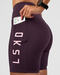Woman wearing Rep Ultra High-Rise 6" Short Pockets - Midnight Plum-Marshmallow | Model:Rhiley | Size:S | Thumbnail Index: 0