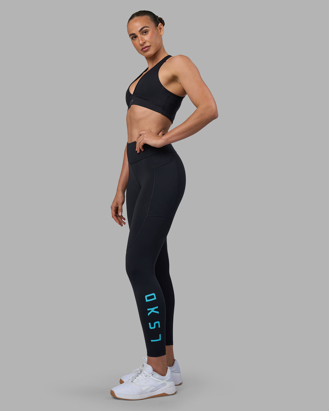 Woman wearing Rep Ultra High-Rise 7/8 Legging Pockets - Black-Blue Atoll | Model:Sophie | Size:S - view 5
