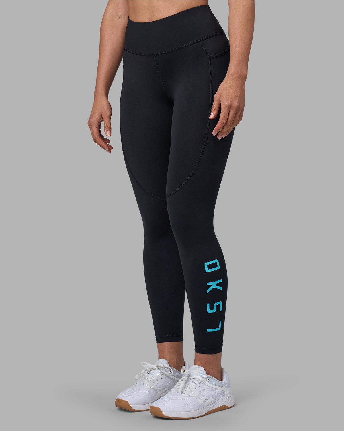 Woman wearing Rep Ultra High-Rise 7/8 Legging Pockets - Black-Blue Atoll | Model:Sophie | Size:S