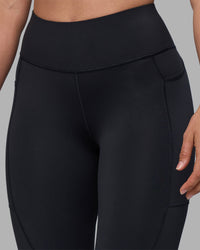 Woman wearing Rep Ultra High-Rise 7/8 Legging Pockets - Black-Blue Atoll | Model:Sophie | Size:S | Thumbnail Index: 7
