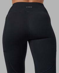 Woman wearing Rep Ultra High-Rise 7/8 Legging Pockets - Black-Blue Atoll | Model:Sophie | Size:S | Thumbnail Index: 8