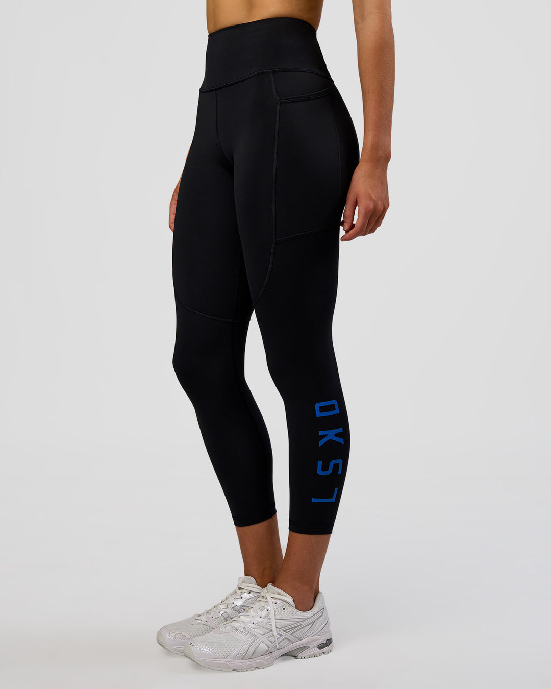 Woman wearing Rep Ultra High-Rise 7/8 Legging Pockets - Black-Electric Indigo | Model:Evie | Size:S - view 1