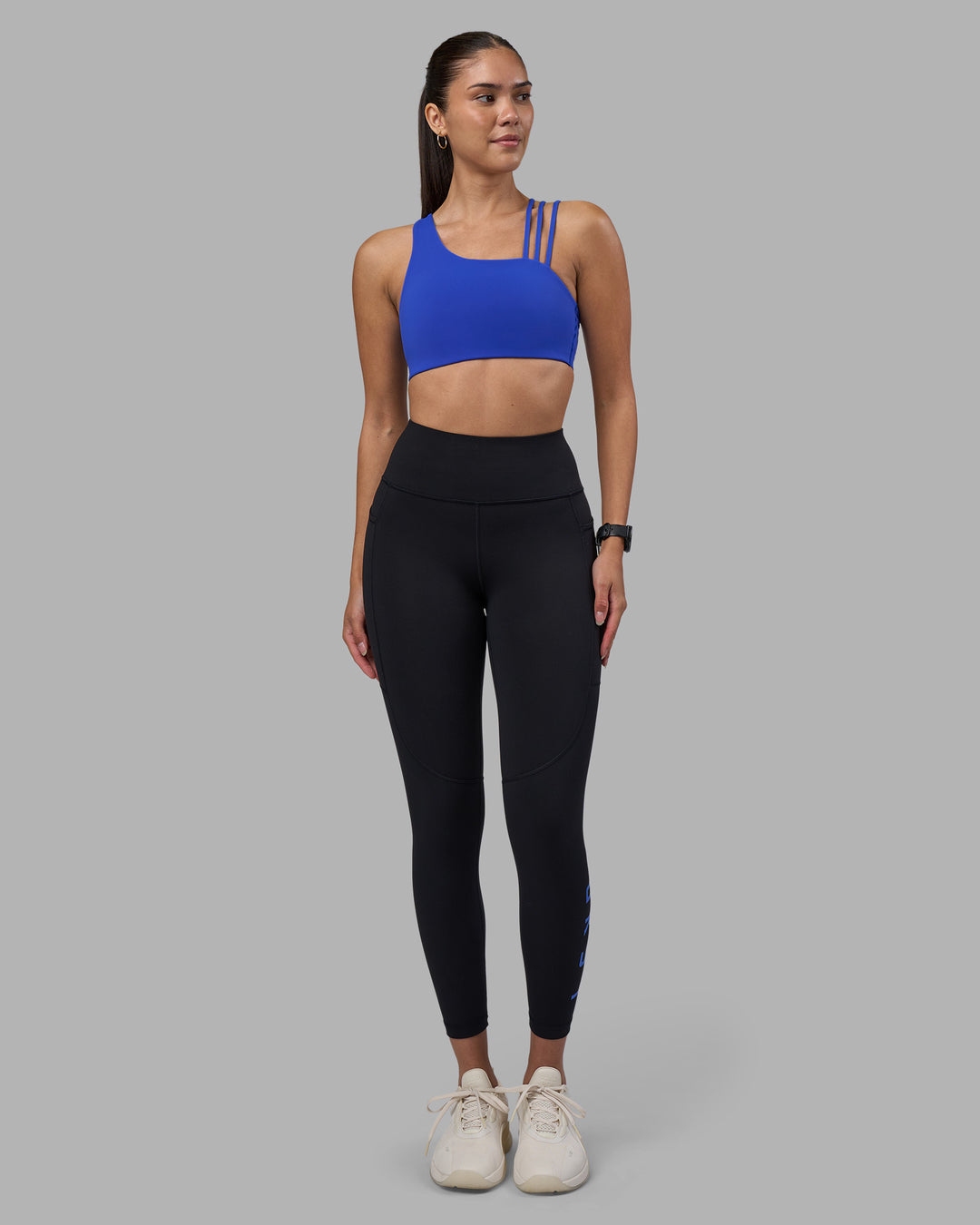 Woman wearing Rep Ultra High-Rise 7/8 Legging Pockets - Black-Power Cobalt | Model:Rhiley | Size:S - view 2