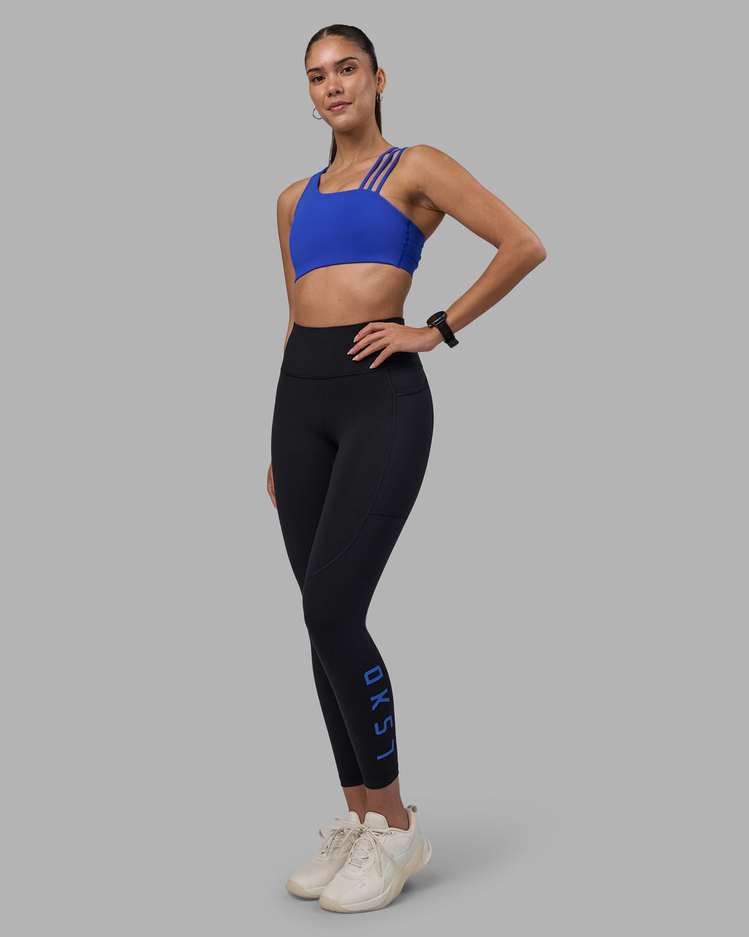 Woman wearing Rep Ultra High-Rise 7/8 Legging Pockets - Black-Power Cobalt | Model:Rhiley | Size:S - view 5
