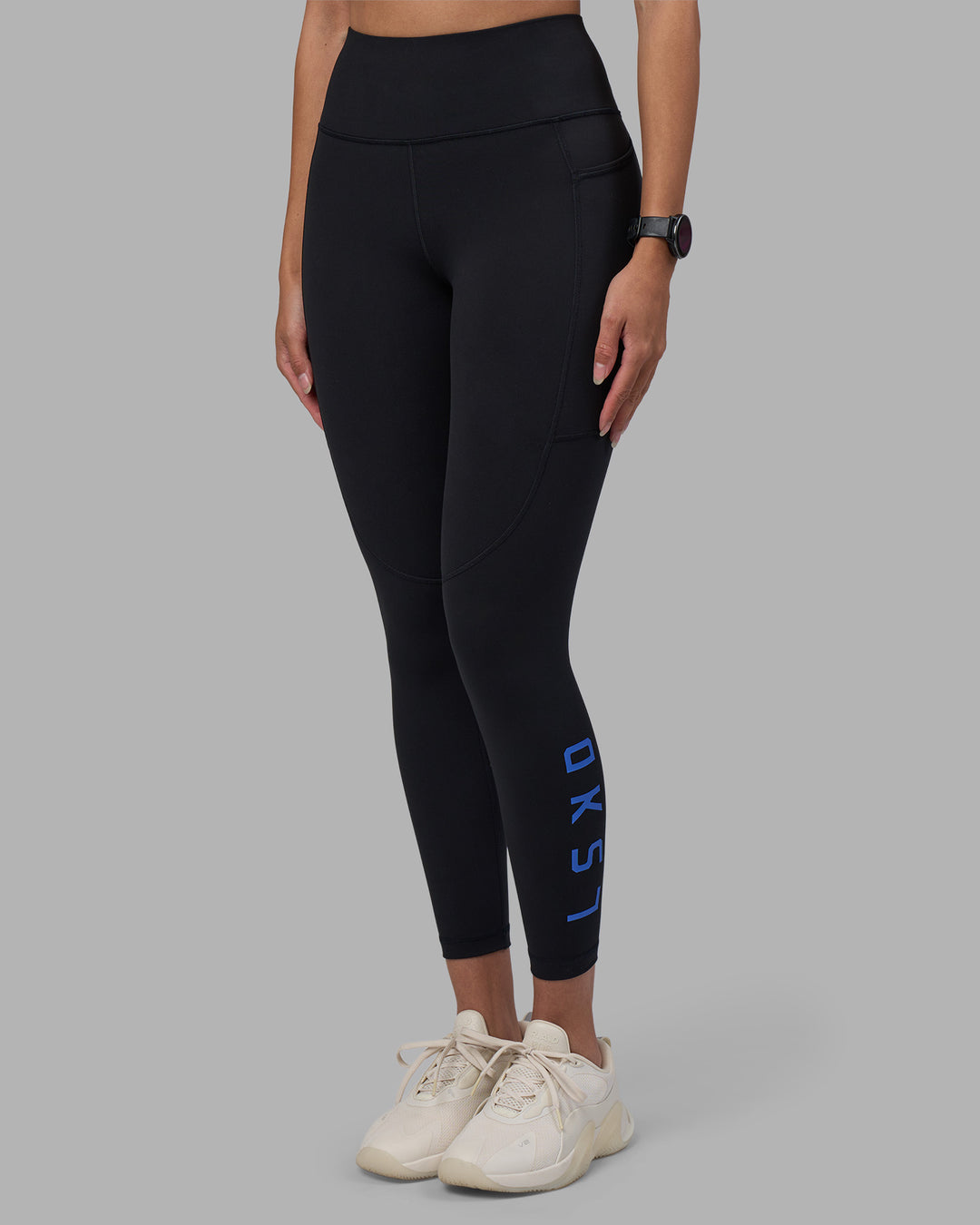 Woman wearing Rep Ultra High-Rise 7/8 Legging Pockets - Black-Power Cobalt | Model:Rhiley | Size:S - view 1