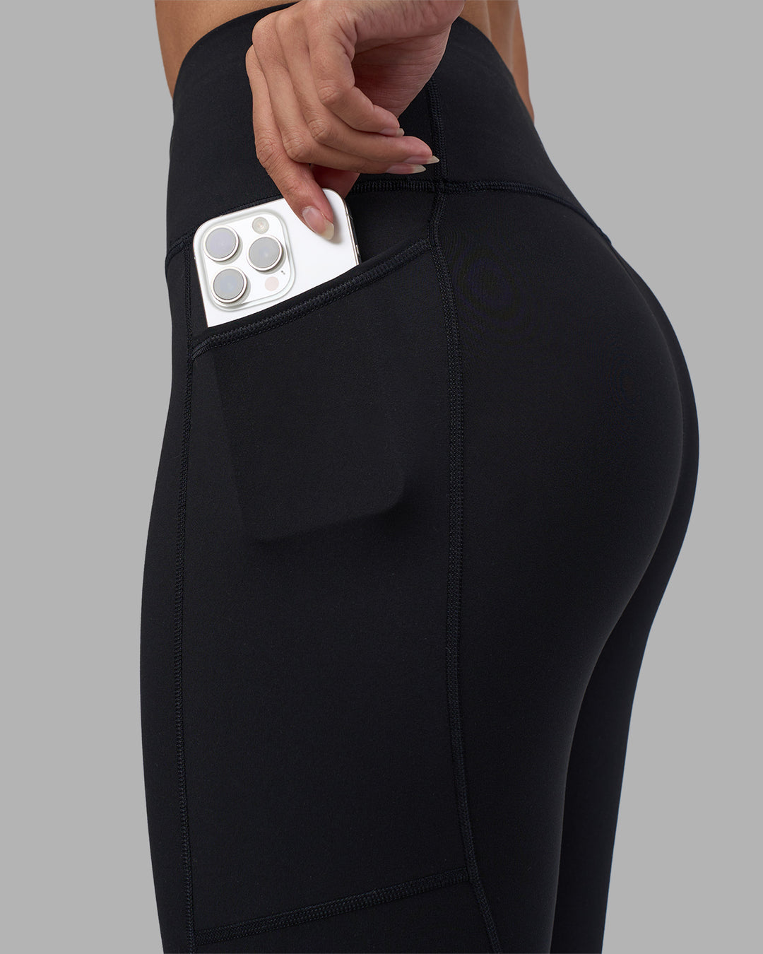 Woman wearing Rep Ultra High-Rise 7/8 Legging Pockets - Black-Power Cobalt | Model:Rhiley | Size:S - view 3