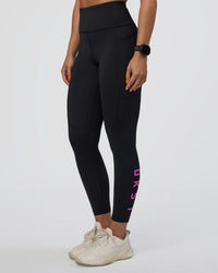 Woman wearing Rep Ultra High-Rise 7/8 Legging Pockets - Black-Ultra Fuchsia | Model:Abbey | Size:S | Thumbnail Index: 0