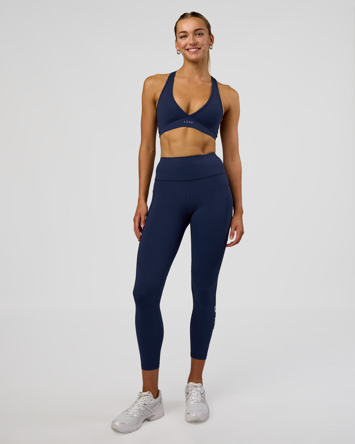 Woman wearing Rep Ultra High-Rise 7/8 Legging Pockets - Future Navy-White | Model:Evie | Size:S