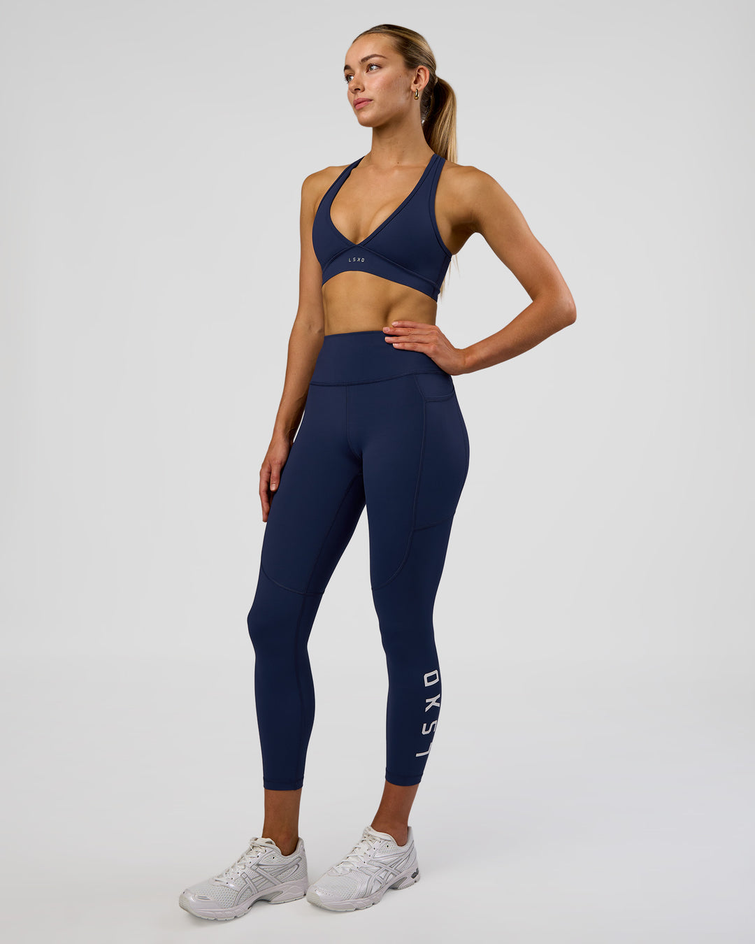 Woman wearing Rep Ultra High-Rise 7/8 Legging Pockets - Future Navy-White | Model:Evie | Size:S - view 5