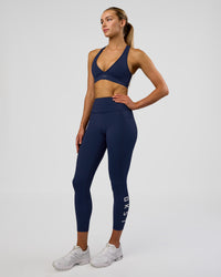 Woman wearing Rep Ultra High-Rise 7/8 Legging Pockets - Future Navy-White | Model:Evie | Size:S | Thumbnail Index: 4
