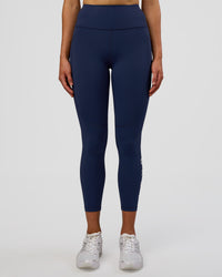 Woman wearing Rep Ultra High-Rise 7/8 Legging Pockets - Future Navy-White | Model:Evie | Size:S | Thumbnail Index: 6