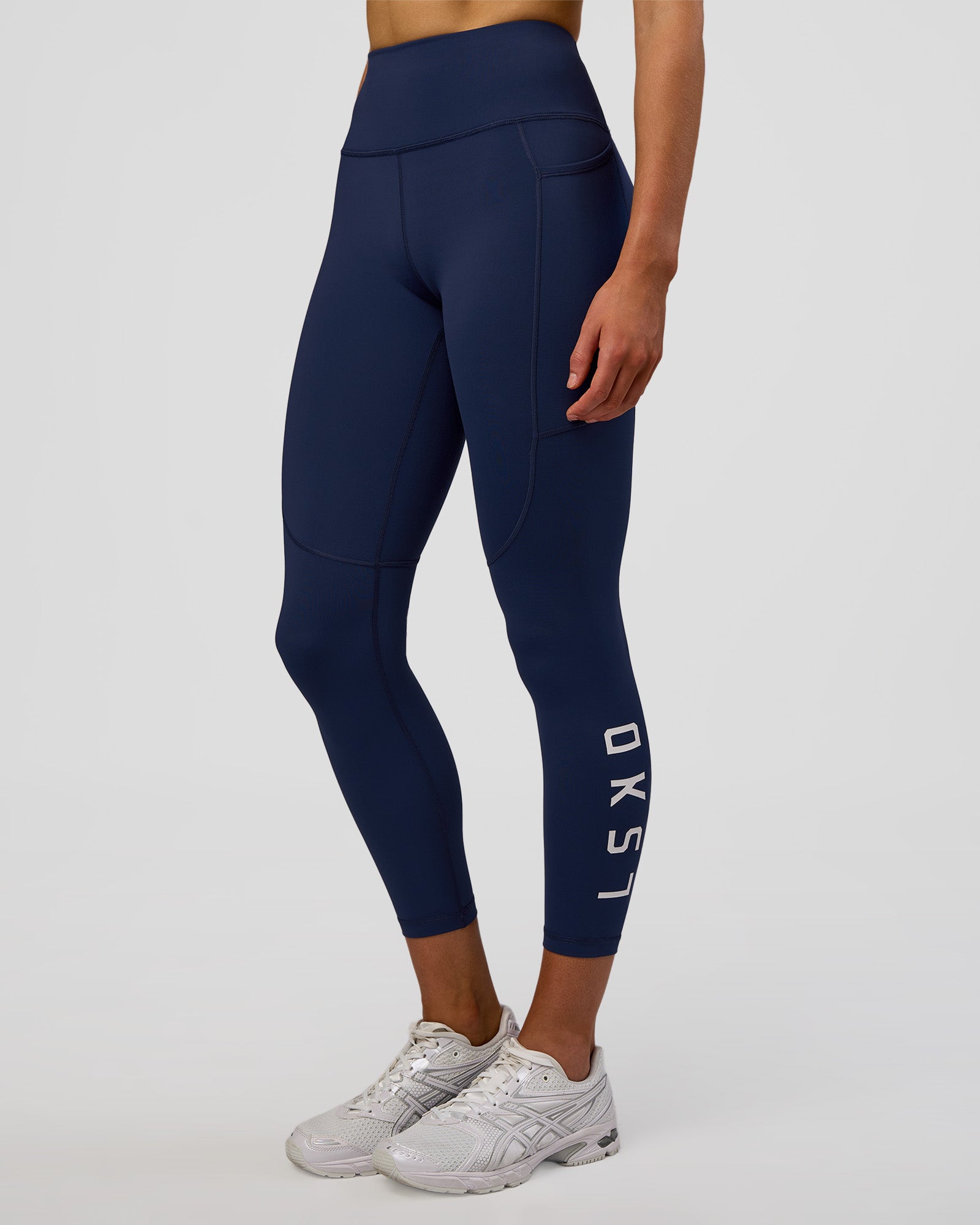 Woman wearing Rep Ultra High-Rise 7/8 Legging Pockets - Future Navy-White | Model:Evie | Size:S