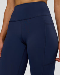 Woman wearing Rep Ultra High-Rise 7/8 Legging Pockets - Future Navy-White | Model:Evie | Size:S | Thumbnail Index: 7