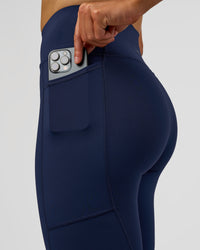 Woman wearing Rep Ultra High-Rise 7/8 Legging Pockets - Future Navy-White | Model:Evie | Size:S | Thumbnail Index: 5