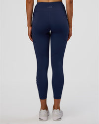 Woman wearing Rep Ultra High-Rise 7/8 Legging Pockets - Future Navy-White | Model:Evie | Size:S | Thumbnail Index: 3