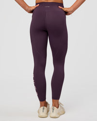 Woman wearing Rep Ultra High-Rise 7/8 Legging Pockets - Midnight Plum-Marshmallow | Model:Emelia | Size:S | Thumbnail Index: 5