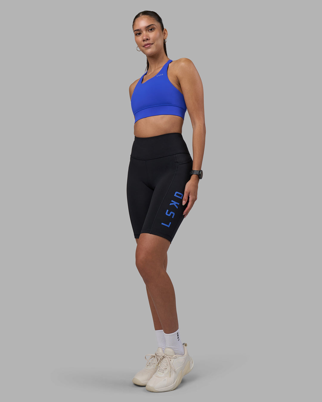 Woman wearing Rep Ultra High-Rise 9" Short Pockets - Black-Power Cobalt | Model:Rhiley | Size:S - view 5