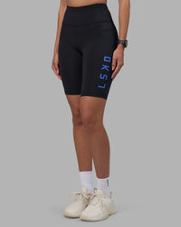 Woman wearing Rep Ultra High-Rise 9" Short Pockets - Black-Power Cobalt | Model:Rhiley | Size:S | Thumbnail Index: 0