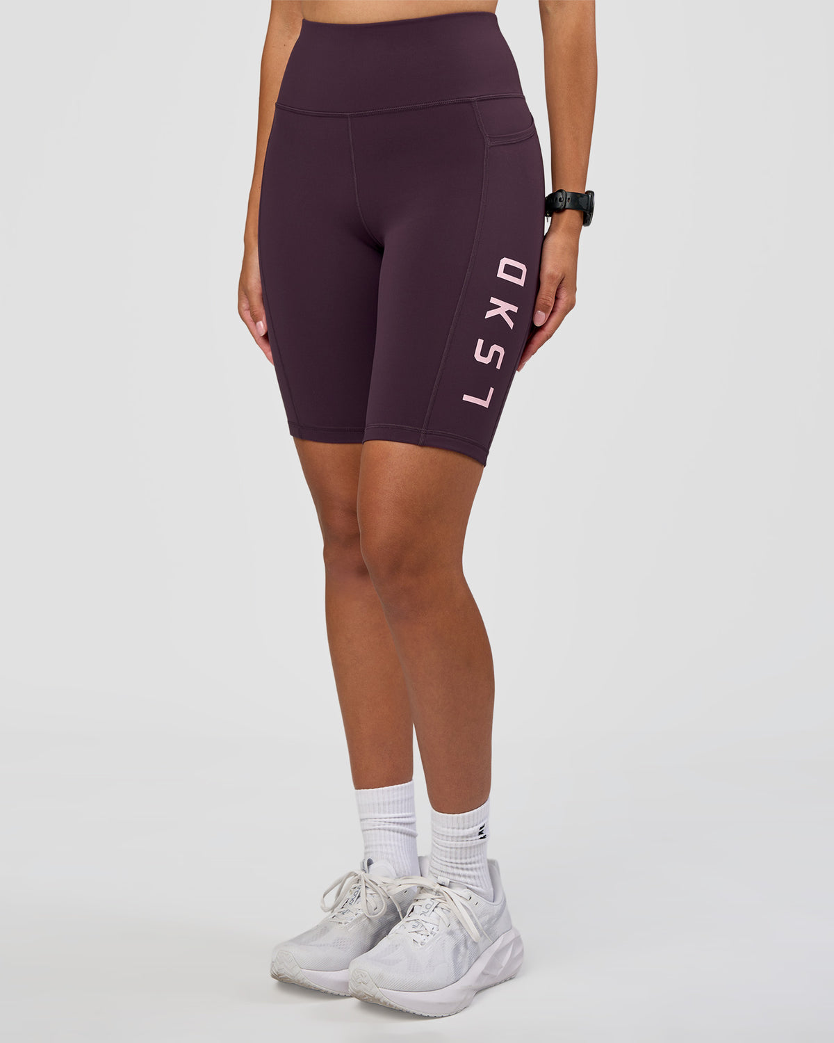 Woman wearing Rep Ultra High-Rise 9" Short Pockets - Midnight Plum-Marshmallow | Model:Rhiley | Size:S