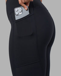 Woman wearing Rep Ultra High-Rise Full Length Legging Pockets - Black-Blue Atoll | Model:Sophie | Size:S | Thumbnail Index: 2
