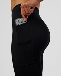 Woman wearing Rep Ultra High-Rise Full Length Legging Pockets - Black-Electric Indigo | Model:Evie | Size:S | Thumbnail Index: 1