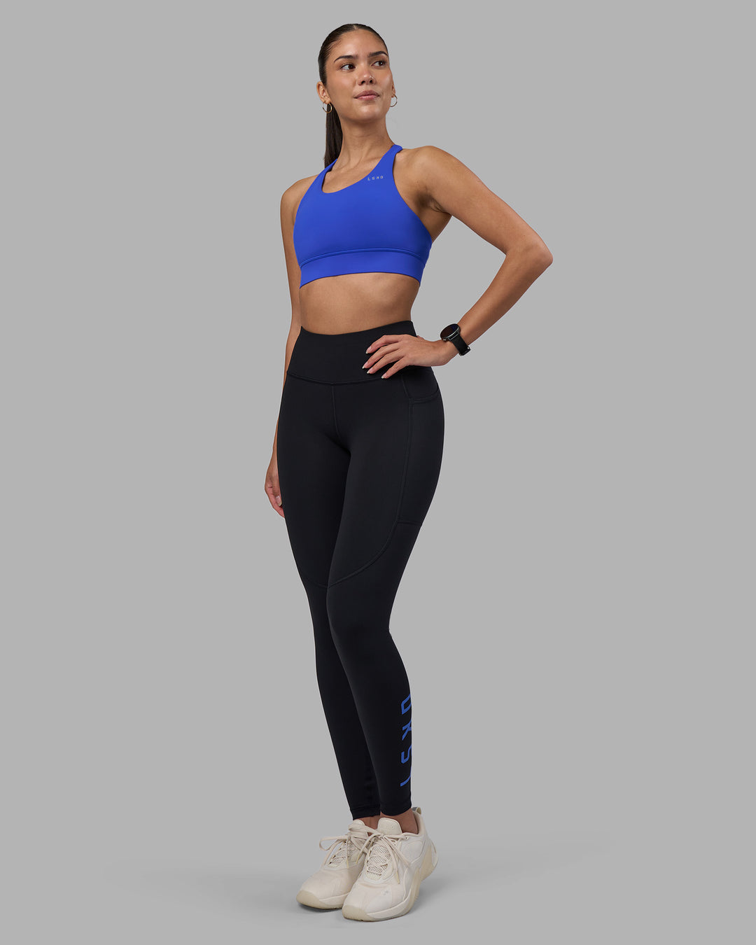 Woman wearing Rep Ultra High-Rise Full Length Legging Pockets - Black-Power Cobalt | Model:Rhiley | Size:S - view 1