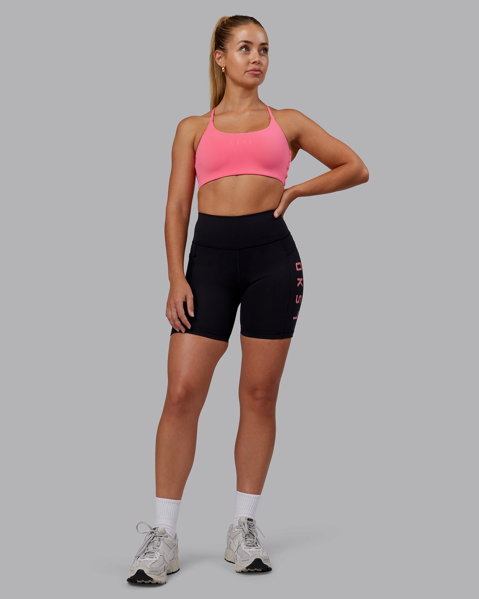 Woman wearing Rep Ultra High-Rise 6" Short Pockets - Black-Pink Lemonade | Model:Hannah | Size:S