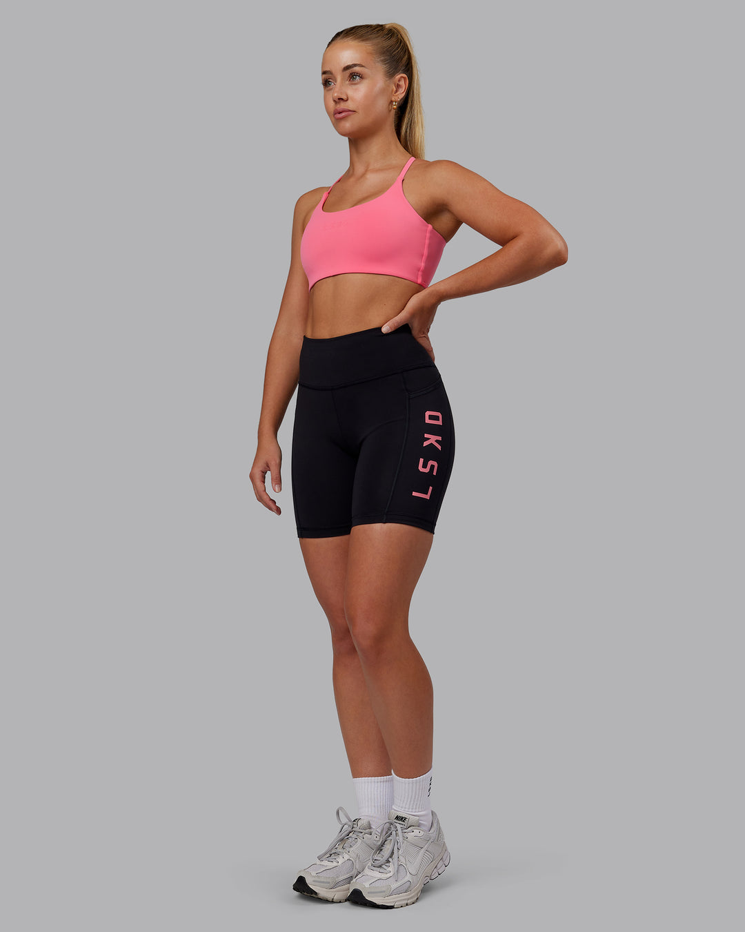 Woman wearing Rep Ultra High-Rise 6" Short Pockets - Black-Pink Lemonade | Model:Hannah | Size:S - view 5